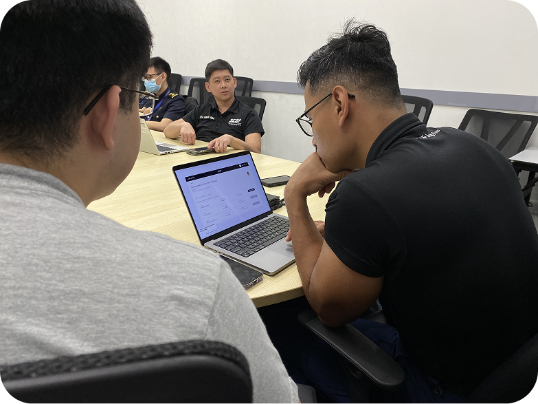 SCDF officers reviewing the Fynder prototype together on a laptop during a usability testing session
